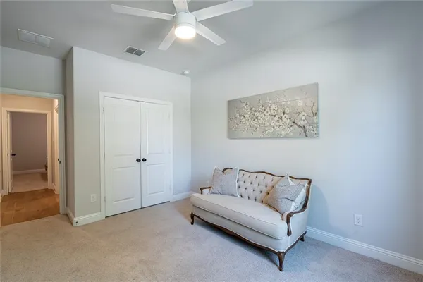 a living room with furniture and a ceiling fan