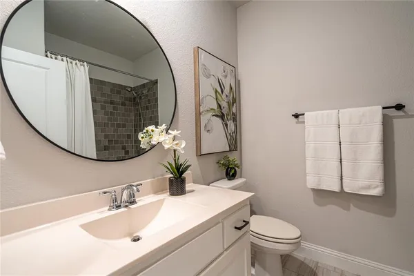 a bathroom with a sink toilet and mirror