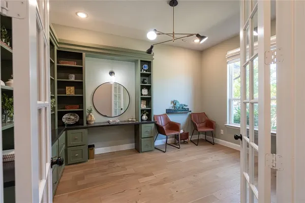 a living room with furniture a large window and gym equipment