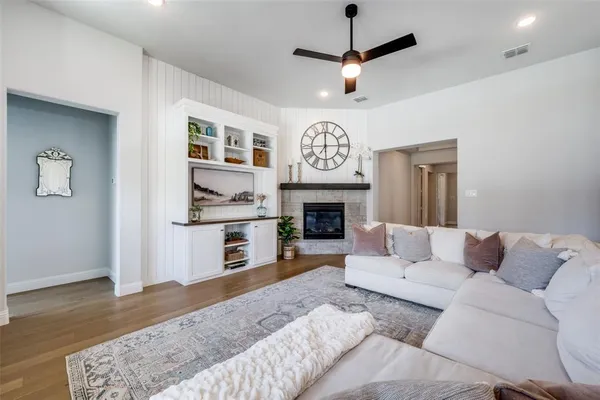 a living room with furniture flat screen tv and a fireplace