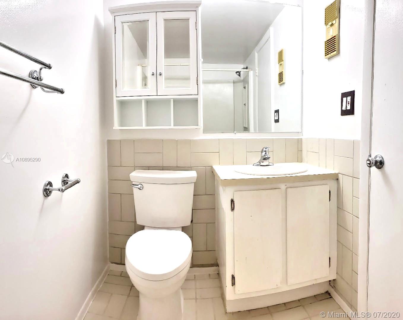 2701 Riverside Drive, Unit 514B Coral Springs, FL 33065 - Photo 11 of 22 a bathroom with a sink toilet and shower