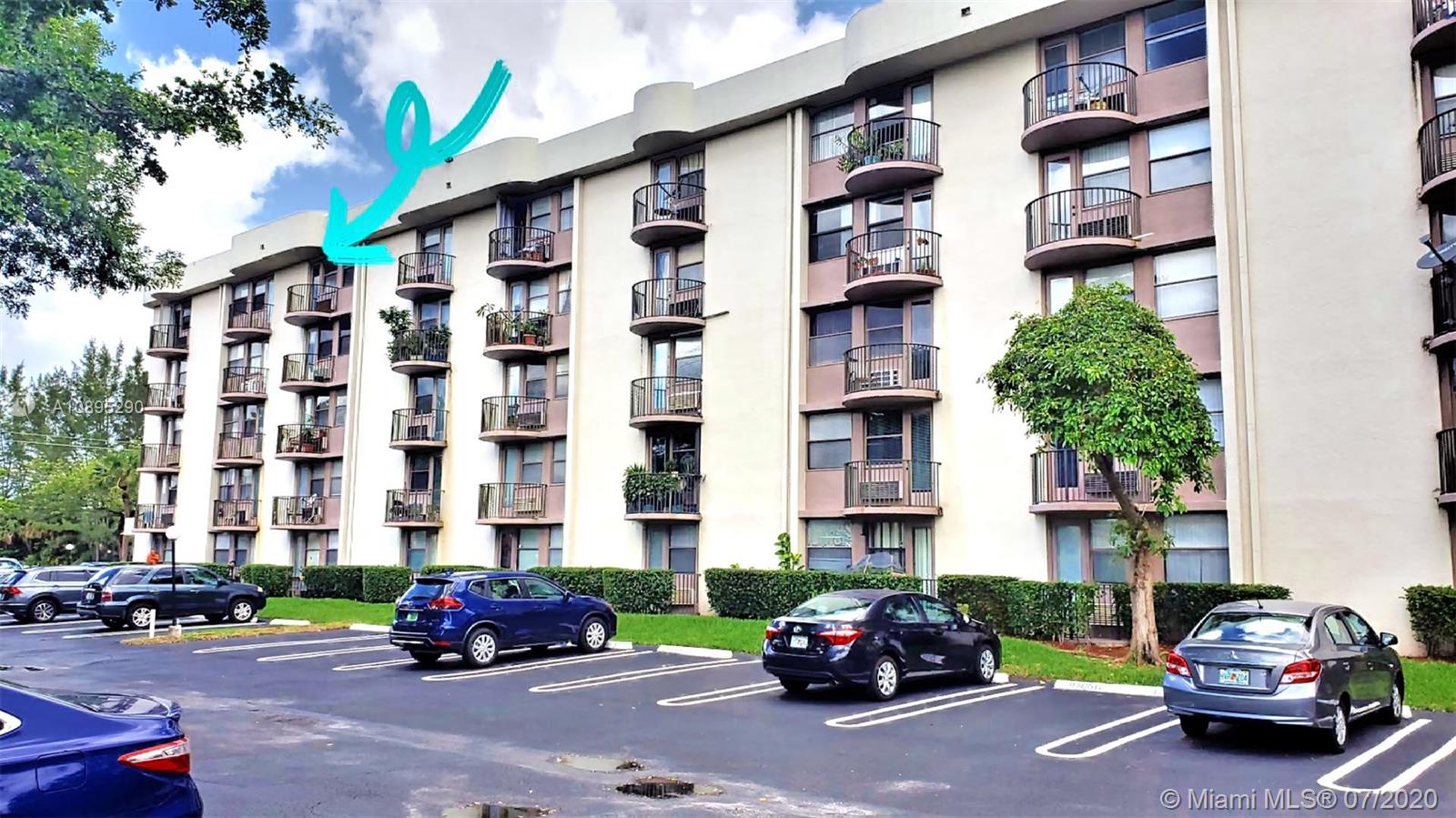 2701 Riverside Drive, Unit 514B Coral Springs, FL 33065 - Photo 21 of 22 a car parked in front of a building and cars parked in front of it