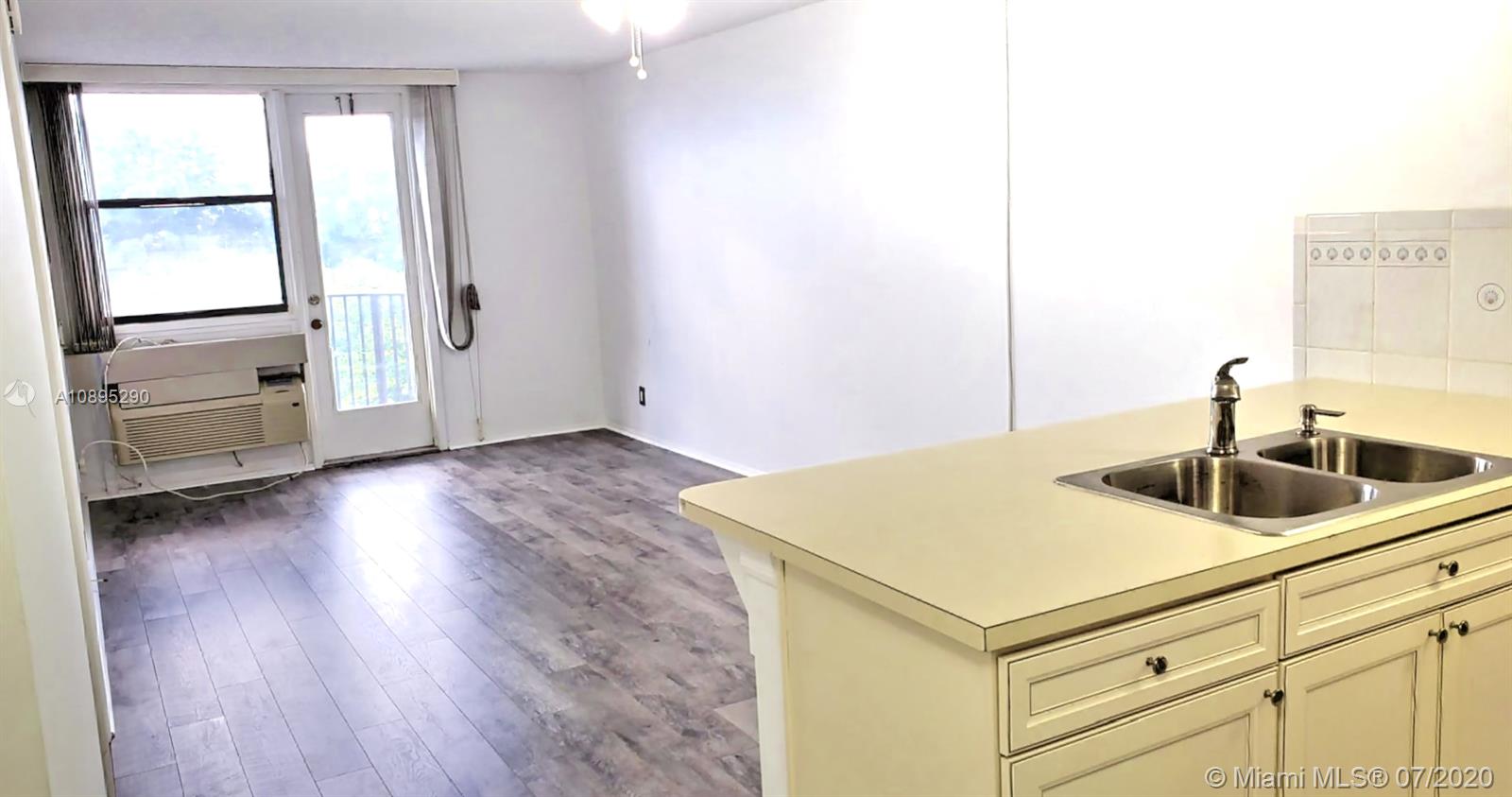 2701 Riverside Drive, Unit 514B Coral Springs, FL 33065 - Photo 3 of 22 a kitchen with a sink and a refrigerator