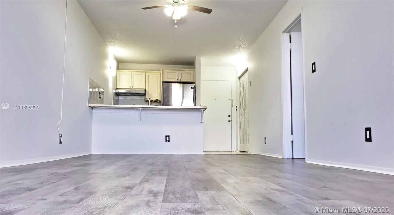 2701 Riverside Drive, Unit 514B Coral Springs, FL 33065 - Photo 4 of 22 wooden floor and white cabinets