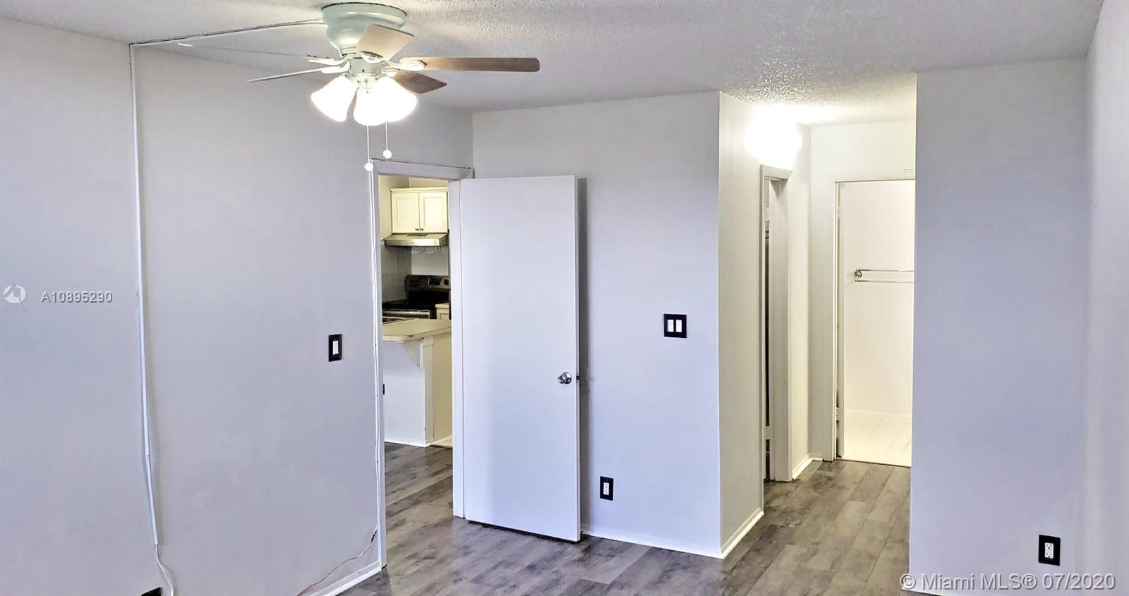 2701 Riverside Drive, Unit 514B Coral Springs, FL 33065 - Photo 7 of 22 wooden floor in an empty room with a mirror