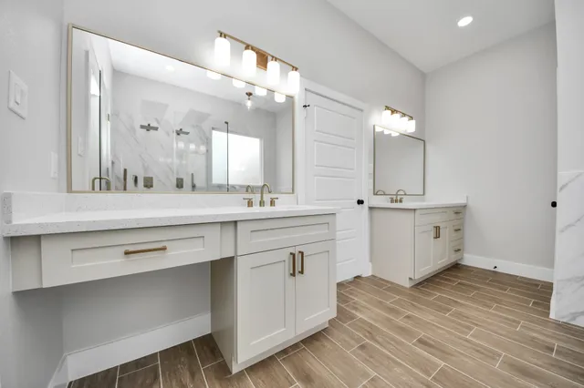 a spacious bathroom with a double vanity sink mirror and