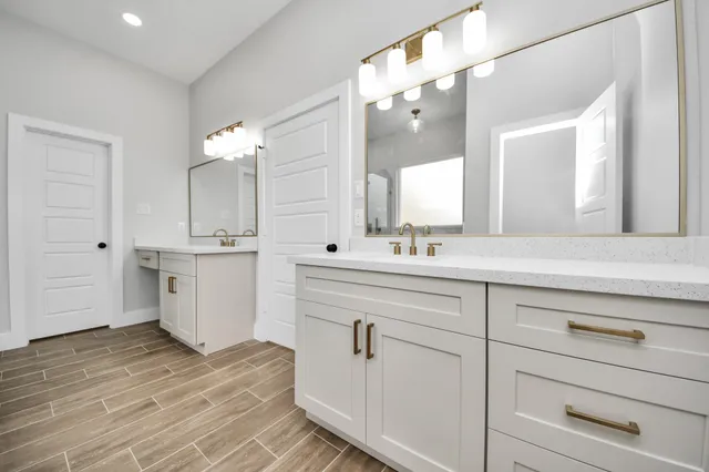 a spacious bathroom with a sink a large mirror and shower