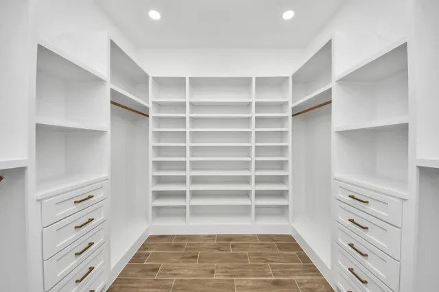 a view of walk in closet with empty racks