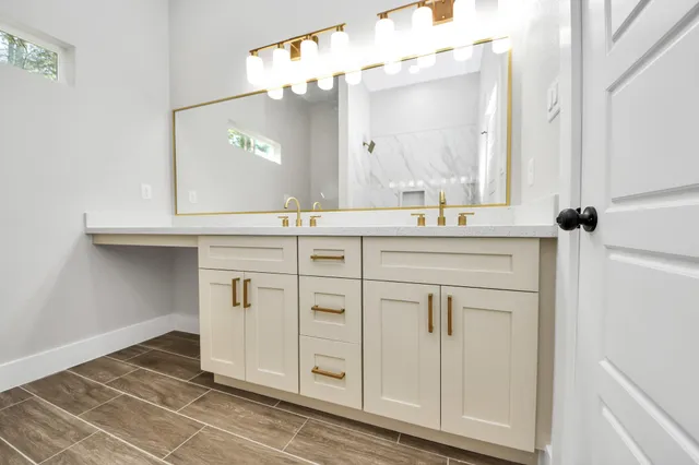 a bathroom with a double vanity sink and a mirror