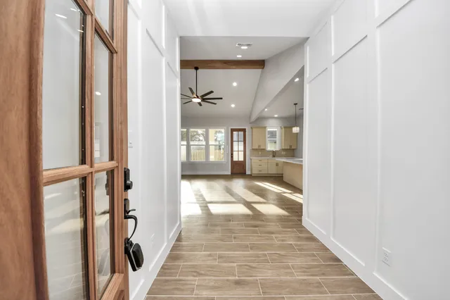 a view of an empty room with window and cabinet