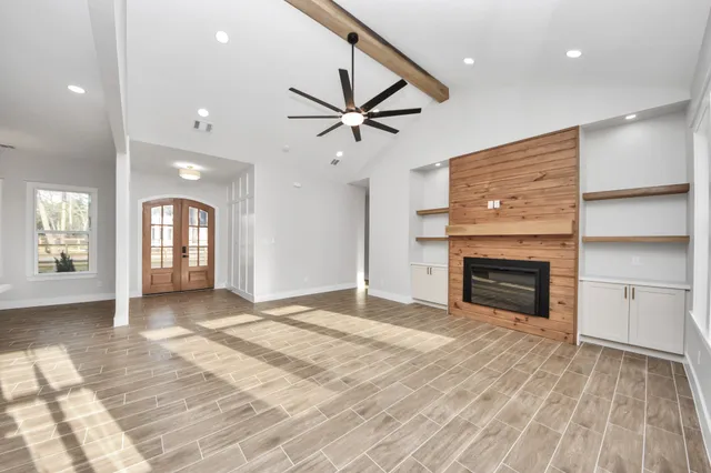 a large white kitchen with a sink stainless steel appliances and cabinets