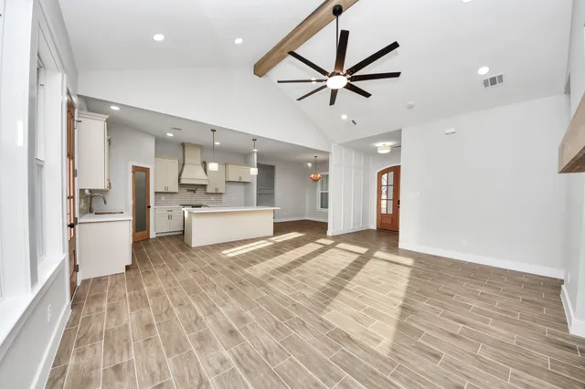 a kitchen with a stove a sink and a refrigerator