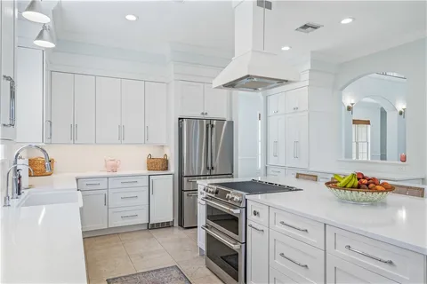 a kitchen with granite countertop a sink stove and refrigerator