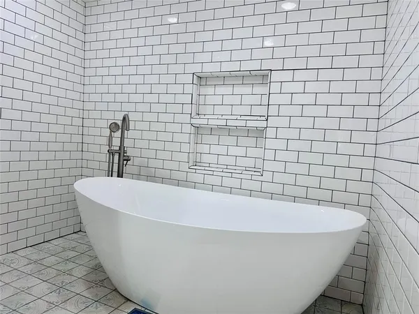 a white bath tub sitting in a bathroom