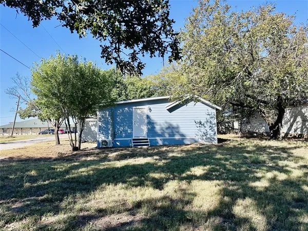 a view of a backyard with large trees