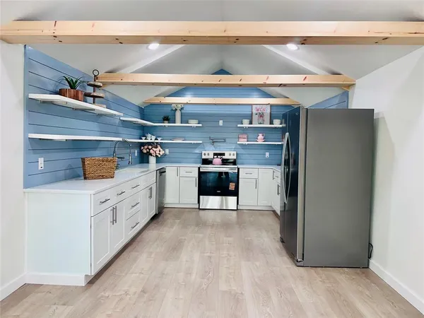 a kitchen with stainless steel appliances granite countertop a refrigerator and a stove