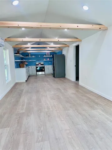 a view of an empty room with a fireplace