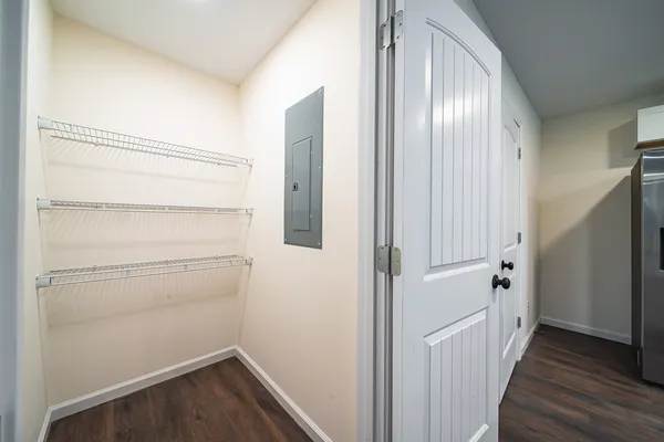 a view of a hallway with wooden floor