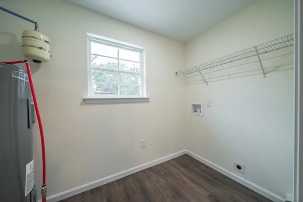 a view of a small space with wooden floor and entryway