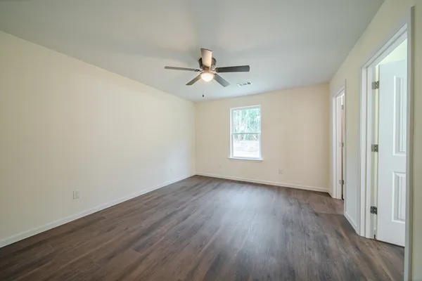 wooden floor in an empty room with a window