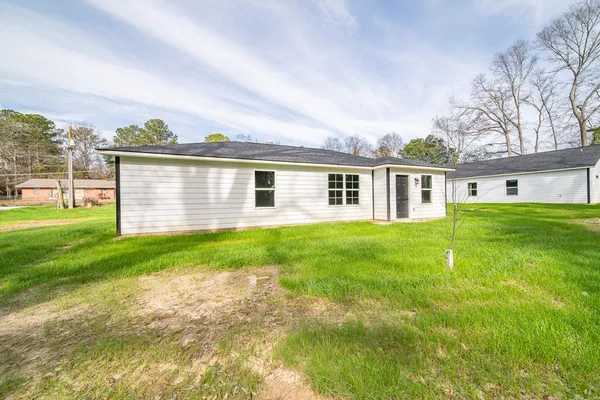a front view of house with yard and green space
