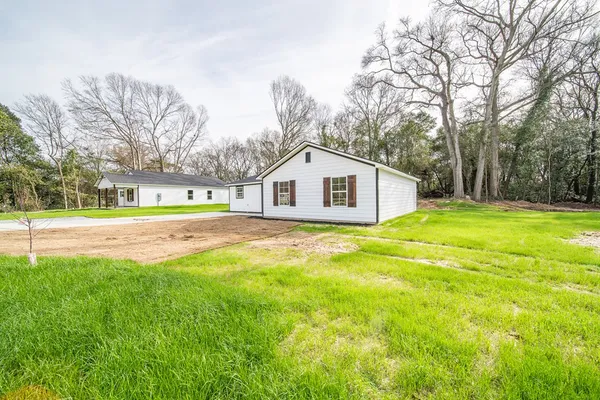 a house view with swimming pool in front of it