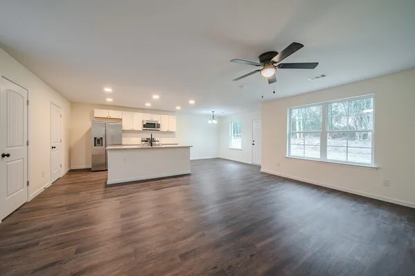 a view of a kitchen with wooden floor and a kitchen