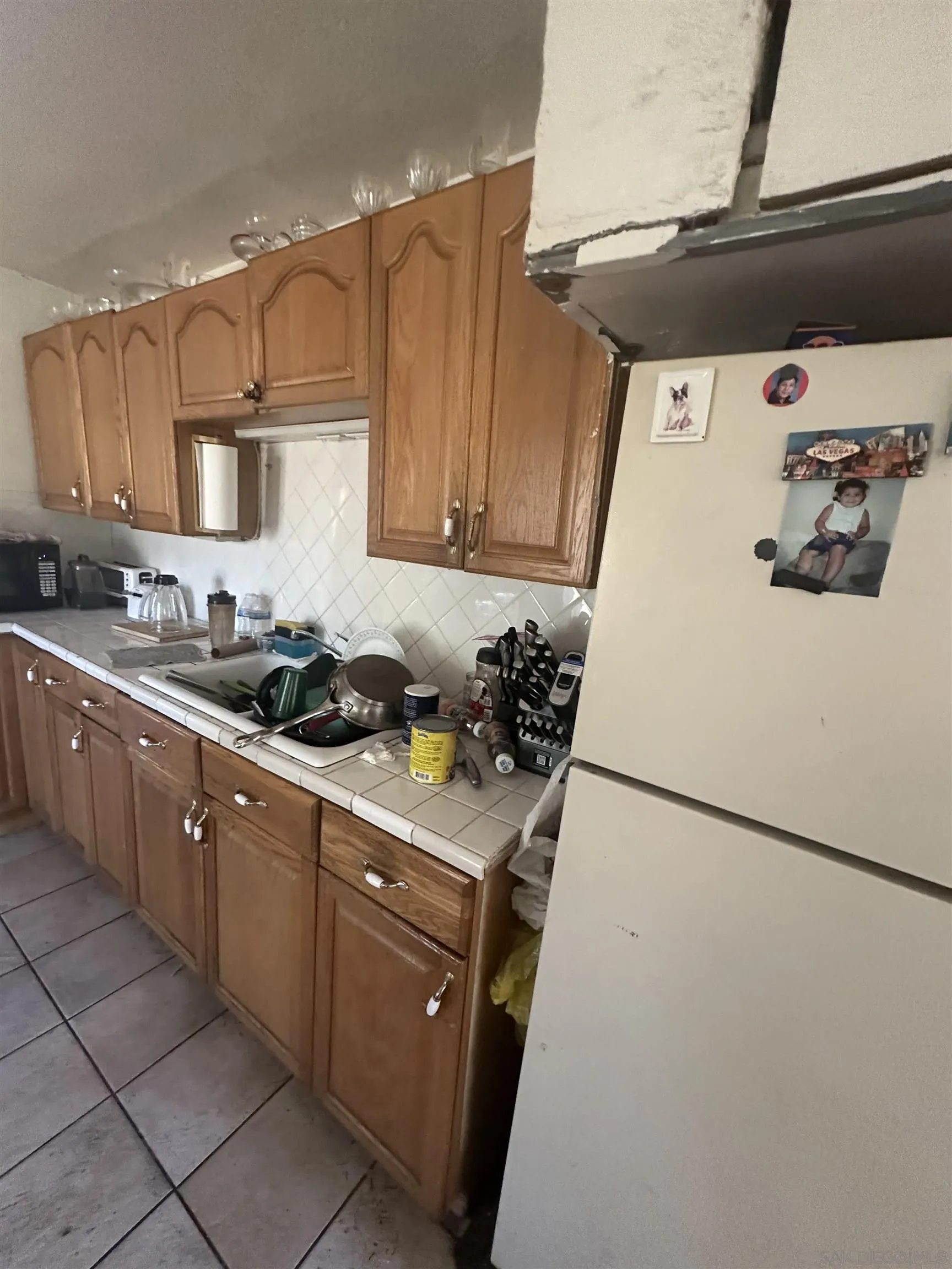 5295 36th Street Riverside, CA 92509 - Photo 5 of 7 a kitchen with a sink a stove and refrigerator