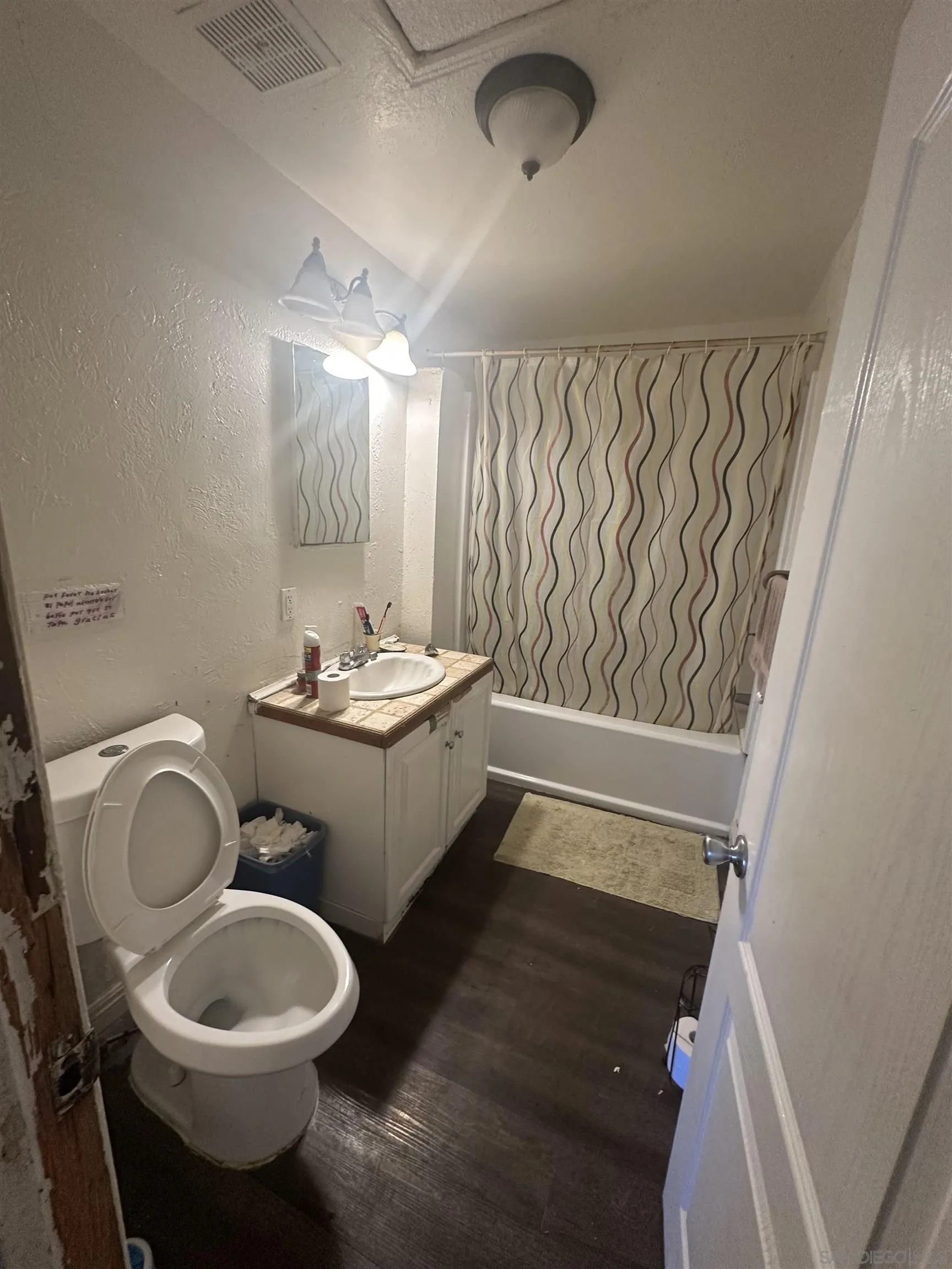 5295 36th Street Riverside, CA 92509 - Photo 7 of 7 a bathroom with a toilet sink and mirror