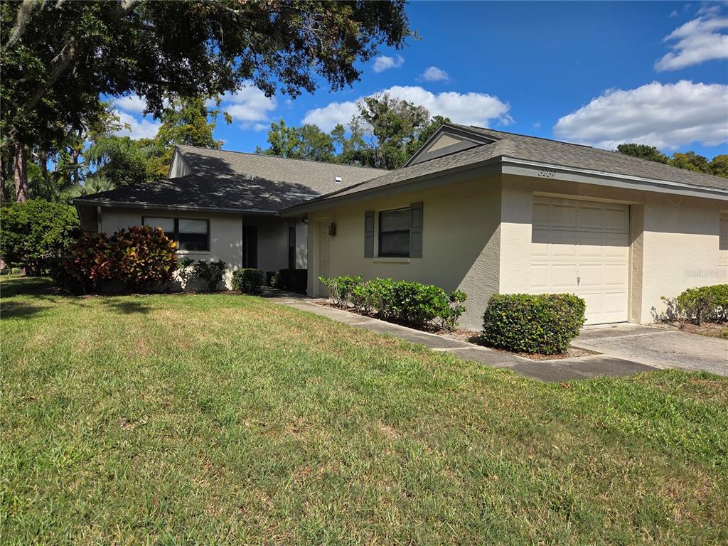 3239 Lori Lane, Unit 3239 New Port Richey, FL 34655 - Photo 1 of 33 a view of a house with a yard