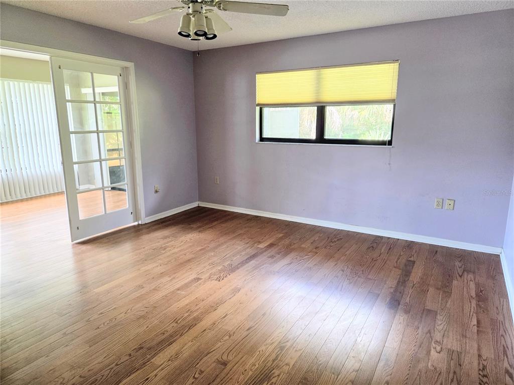 3239 Lori Lane, Unit 3239 New Port Richey, FL 34655 - Photo 14 of 33 an empty room with wooden floor and a window