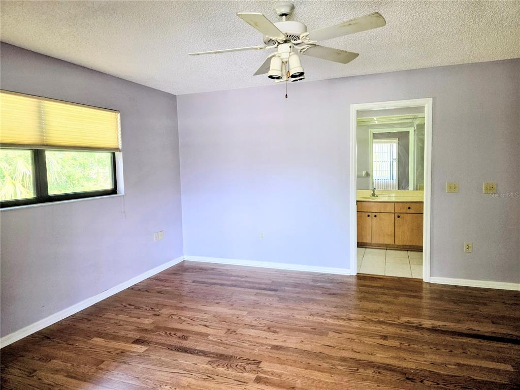 3239 Lori Lane, Unit 3239 New Port Richey, FL 34655 - Photo 15 of 33 a view of an empty room with wooden floor and a window