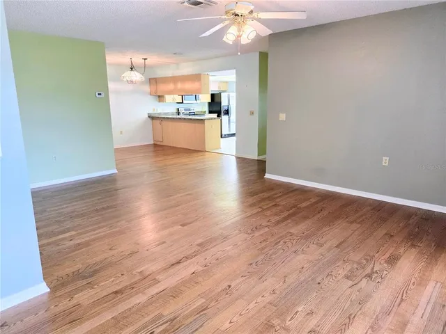 a view of a kitchen with a sink and wooden floor