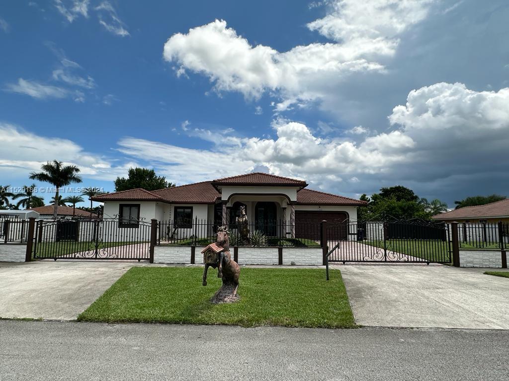 a front view of a house with garden and plants