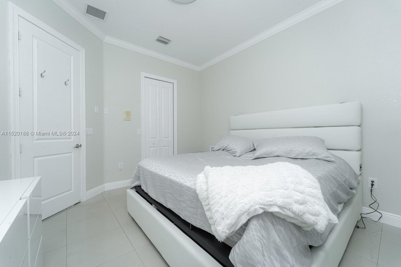 13430 Southwest 192nd Street Miami, FL 33177 - Photo 15 of 37 a bedroom with a bed and hallway