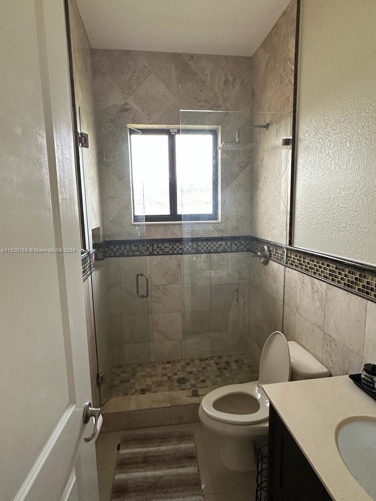 13430 Southwest 192nd Street Miami, FL 33177 - Photo 16 of 37 a bathroom with a sink a toilet and a shower