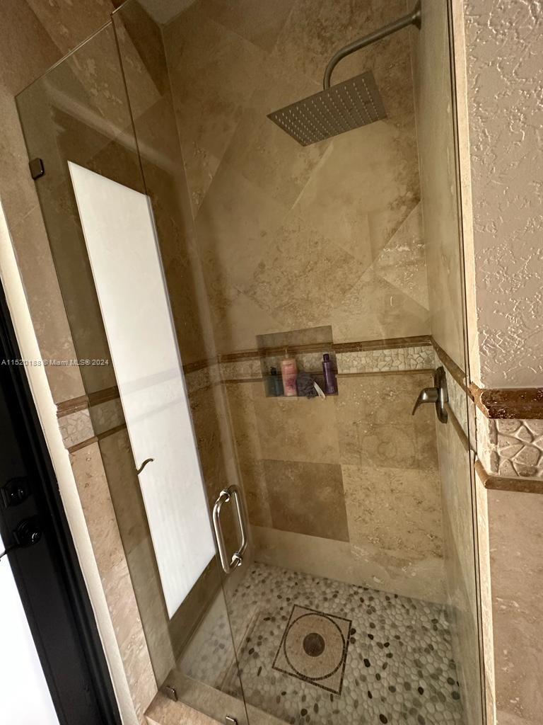 13430 Southwest 192nd Street Miami, FL 33177 - Photo 18 of 37 a bathroom with a shower and a sink