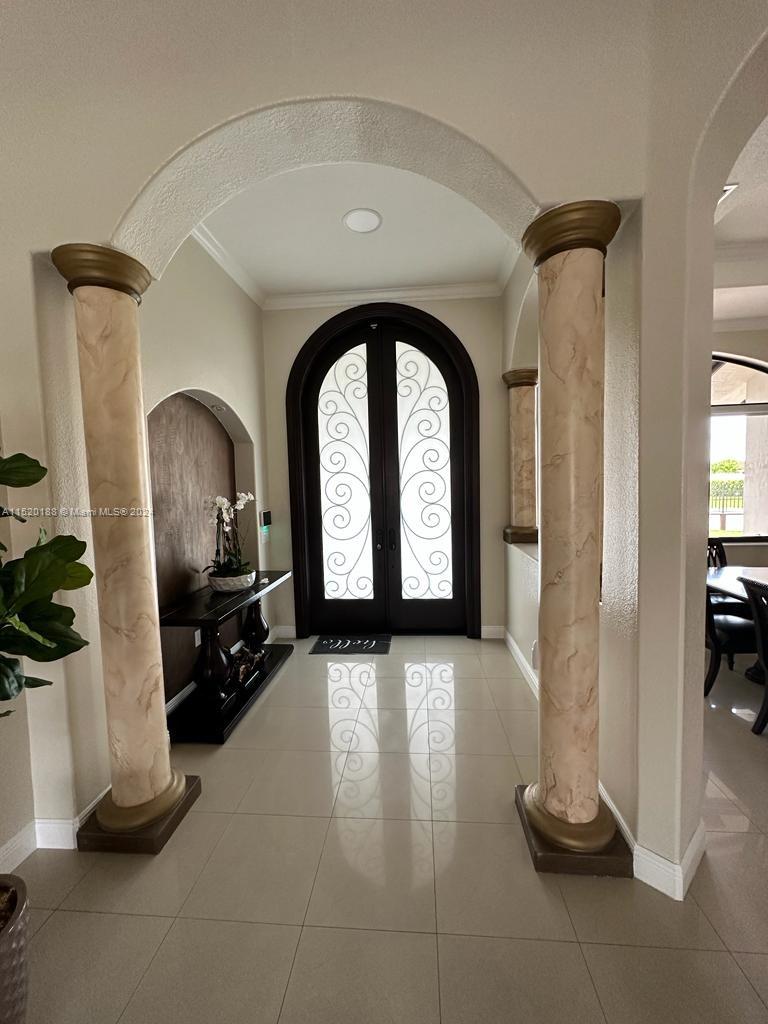 13430 Southwest 192nd Street Miami, FL 33177 - Photo 19 of 37 a view of a hallway with entryway wooden floor and windows