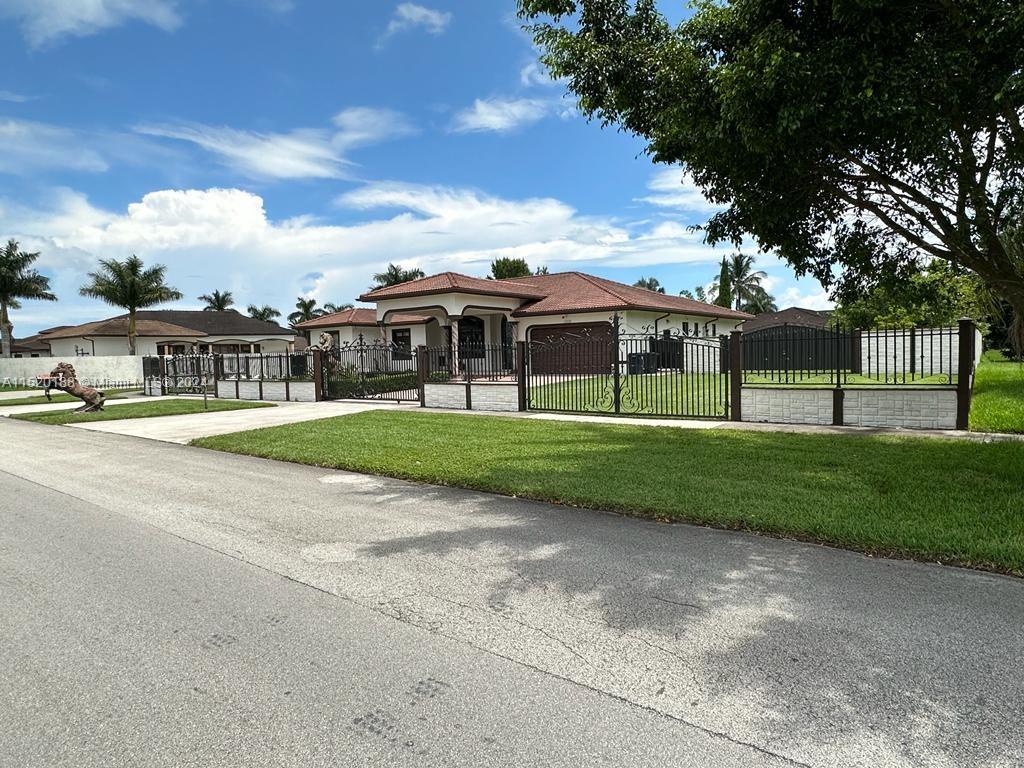 13430 Southwest 192nd Street Miami, FL 33177 - Photo 2 of 37 a view of big yard with a house in the background