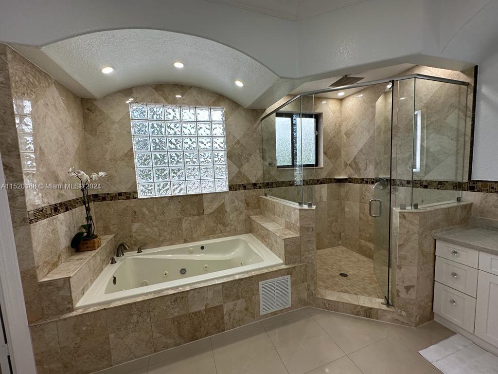 13430 Southwest 192nd Street Miami, FL 33177 - Photo 23 of 37 a bathroom with a bathtub a shower and a sink