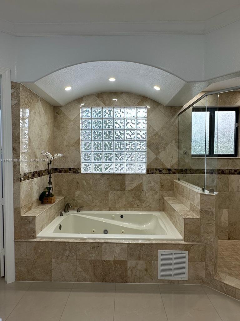 13430 Southwest 192nd Street Miami, FL 33177 - Photo 24 of 37 a bathroom with a bathtub and a shower