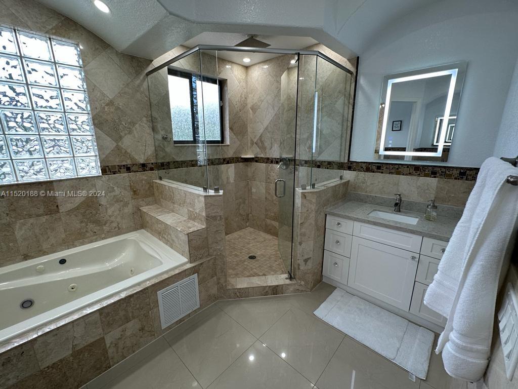 13430 Southwest 192nd Street Miami, FL 33177 - Photo 25 of 37 a bathroom with a bathtub and a sink
