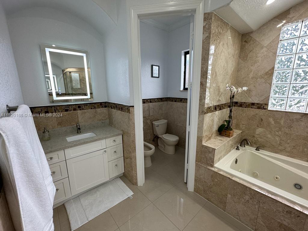 13430 Southwest 192nd Street Miami, FL 33177 - Photo 26 of 37 a bathroom with a tub sink and mirror