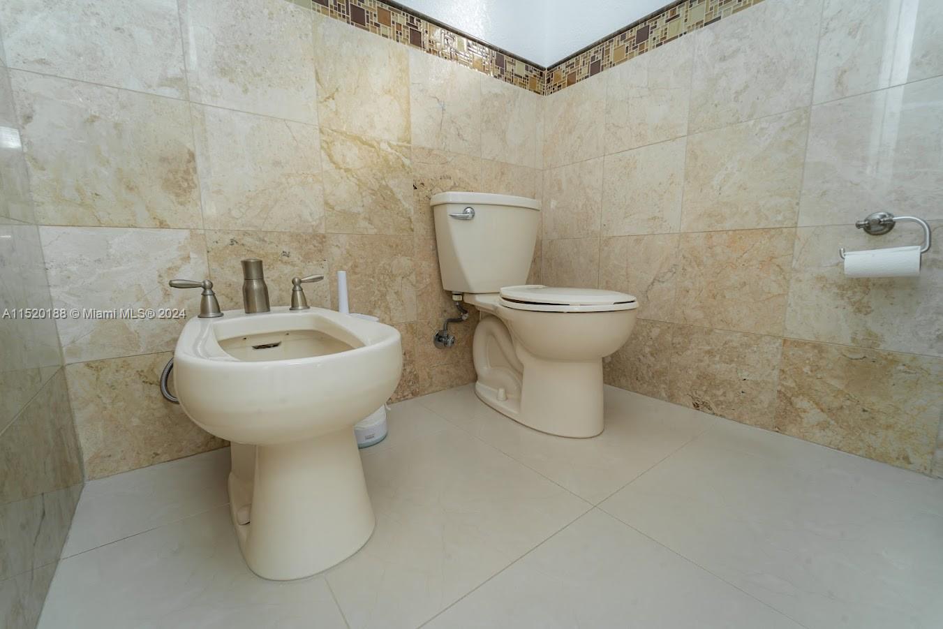13430 Southwest 192nd Street Miami, FL 33177 - Photo 30 of 37 a bathroom with a sink toilet and a mirror