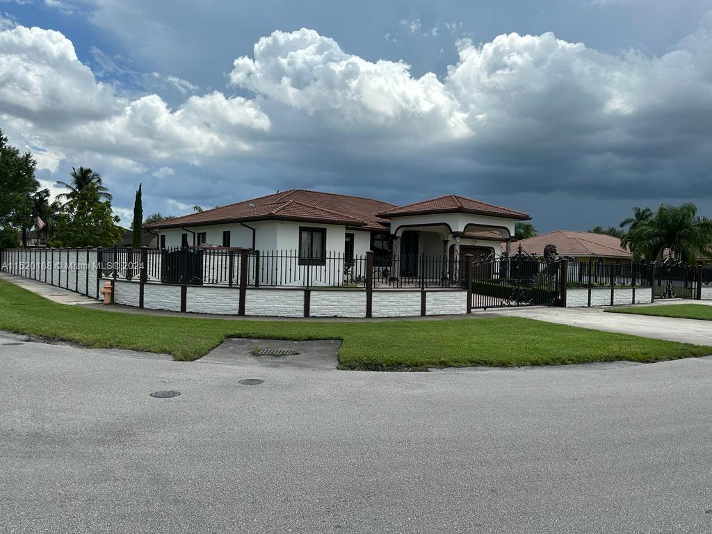13430 Southwest 192nd Street Miami, FL 33177 - Photo 3 of 37 a view of house with a big yard and large trees