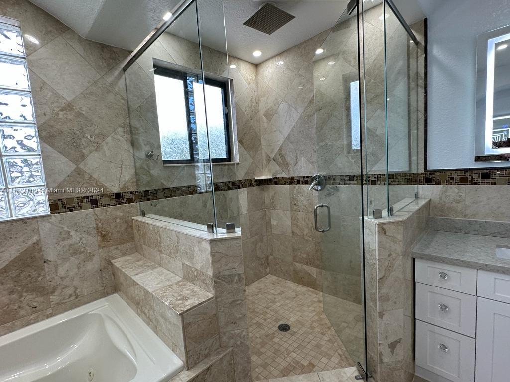 13430 Southwest 192nd Street Miami, FL 33177 - Photo 31 of 37 a bathroom with a granite countertop sink a mirror and shower