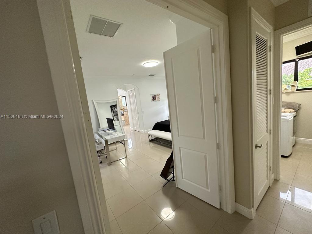 13430 Southwest 192nd Street Miami, FL 33177 - Photo 37 of 37 a view of a hallway with wooden floor and a living room