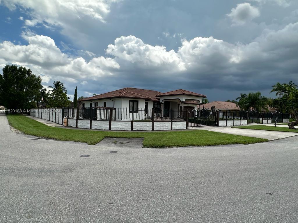 13430 Southwest 192nd Street Miami, FL 33177 - Photo 4 of 37 a view of house with a big yard and large trees
