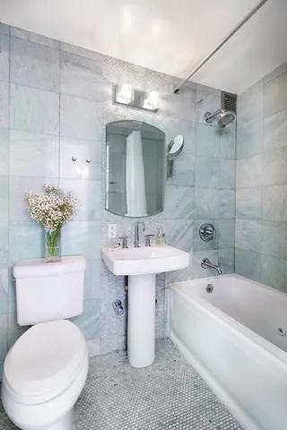 a bathroom with a sink toilet and shower