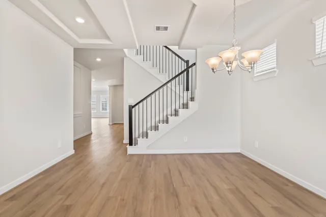 a view of an entryway with wooden floor and windows